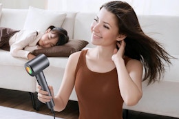 a woman using an ionic hair dryer