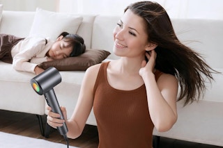 a woman using an ionic hair dryer