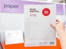 hand holding a pack of filler paper at target