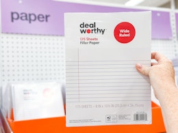 hand holding a pack of filler paper at target