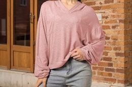 a woman wearing a pink hoodie