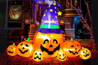 Lifestyle image of a pumpkin Halloween inflatable set up outdoors at night