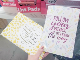 hand holding 2 journals