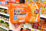 hand holding a pack of top ramen