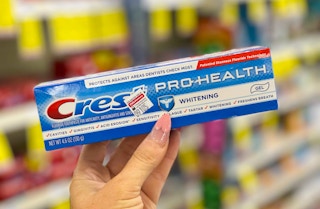 hand holding box of Crest Pro-Health Toothpaste