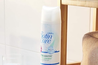 A bottle of Gillette shaving gel next to a shower