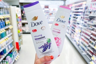 hand holding two bottles of dove body wash