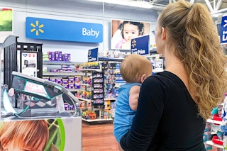 a woman and her baby in the baby section at walmart