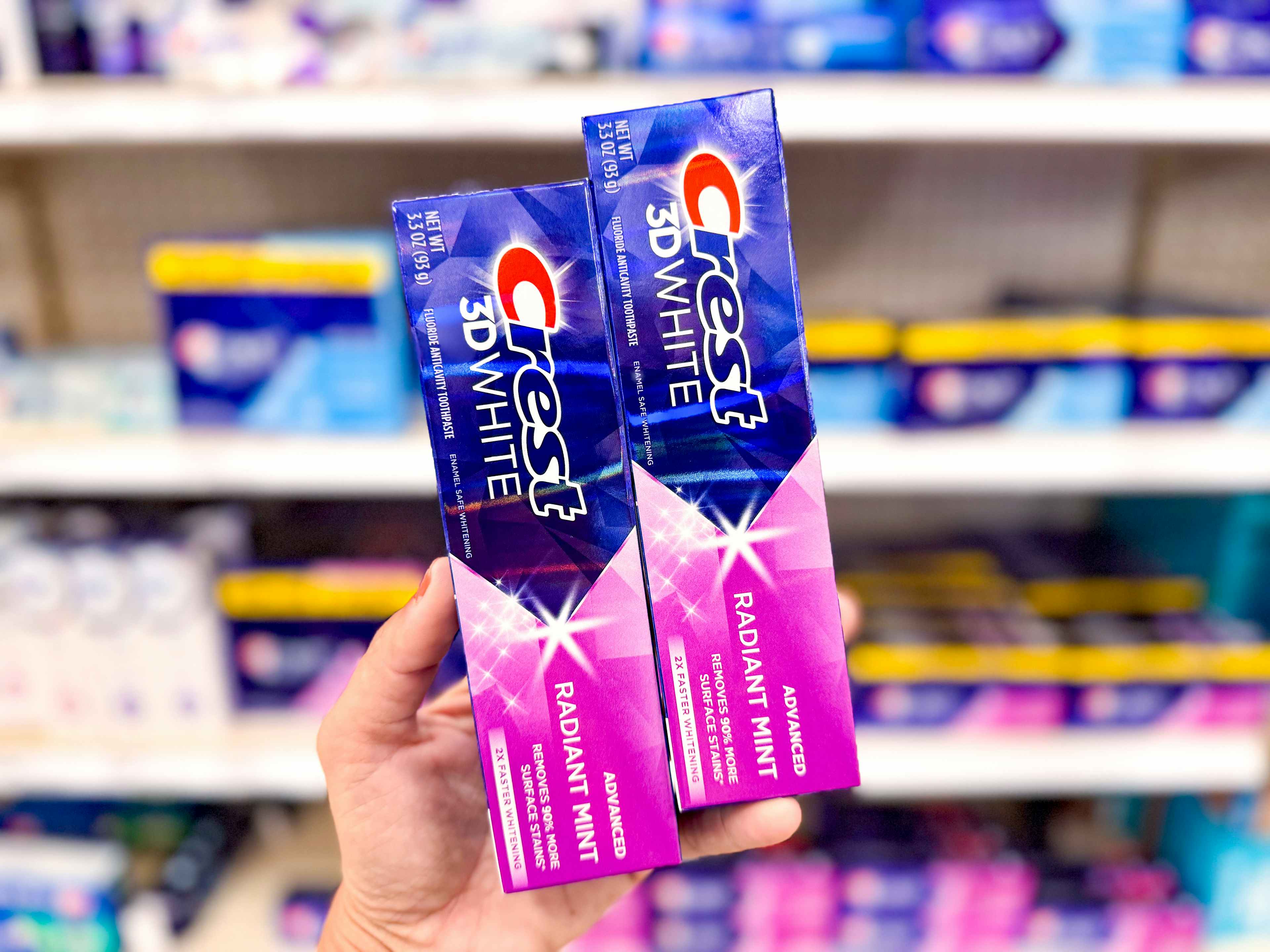 hand holding two crest 3d advanced toothpastes at target