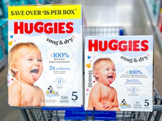 two boxes of huggies snug & dry diapers in walmart cart