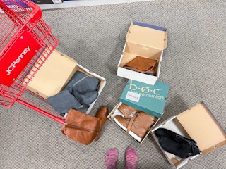 boxes of boots on ground to try on