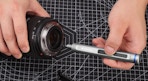 a hand using a screwdriver on a camera 