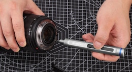 a hand using a screwdriver on a camera 