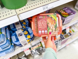 hand holding an ello glass meal prep set in front of a target shelf