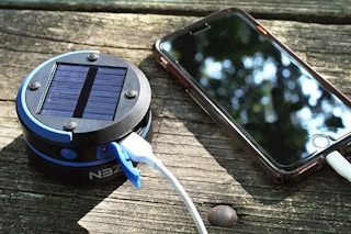A phone plugged in to a solar lantern