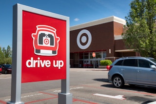 A Target drive up/order pickup sign in the parking lot in front of Target.