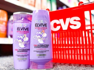 two bottles of l'oreal elvive next to a cvs shopping basket