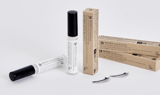 tubes of eyelash serum next to it's packaging 