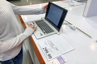 hp chromebook laptop on display with a person touching it at costco