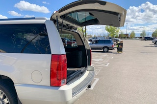 A vehicle with an open trunk waiting for a grocery pickup order.