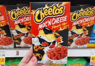 hand holding cheetos mac n cheese at the store