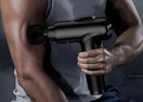 a person using a massage gun on their arm