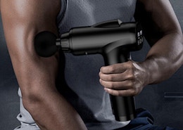 a person using a massage gun on their arm