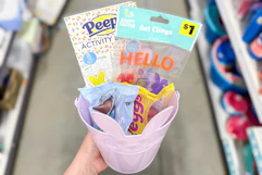 hand holding easter items in a pail