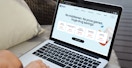 Someone using a laptop to. look at the Mark Cuban Cost Plus drugs website
