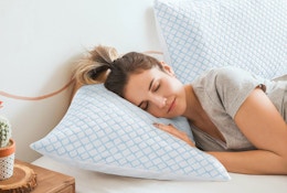 a person laying on a pillow on a bed