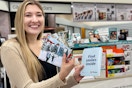 person holding photos at walgreens photo counter