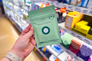 person holding a package of rael beauty miracle patches in front of the shelf