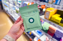person holding a package of rael beauty miracle patches in front of the shelf