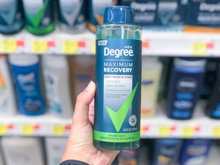 bottle of degree men maximum recovery body wash held in front of other body washes on walmart shelves
