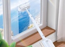 someone steam cleaning a window with a steam mop