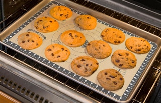 cookies on a baking mat in an oven