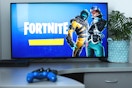 fortnite game on a tv with console and controllers