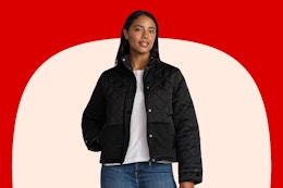 Stock image of a woman wearing a black Time and Tru puffer jacket