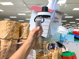hand holding motivational water bottle inside Target