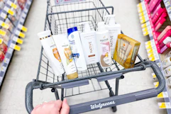 hand pushing a walgreens cart with pantene, head & shoulders, native sponsored