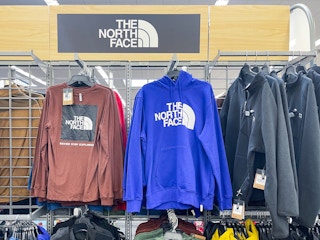 academy north face hoodie hanging on racks in store