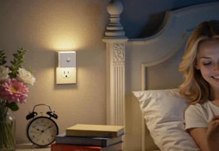 a motion sensor light plugged into a wall.