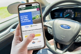 someone on the phone in their car looking at the amazon prime gas deal