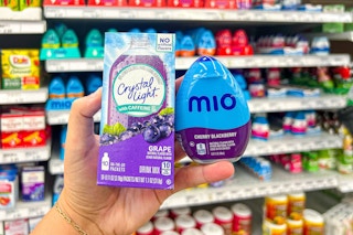 hand holding crystal light and mio water enhancers