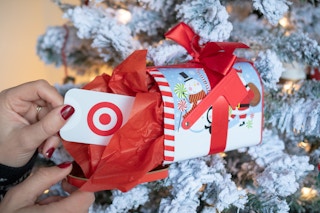 Someone taking a Target gift card out of a Christmas mailbox ornament