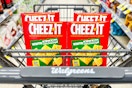 shopping cart filled with four boxes of white cheddar cheez it crackers