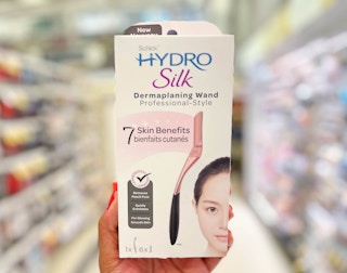 hand holding a Schick Hydro Silk dermaplanning wand box