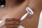 woman shaving her armpits