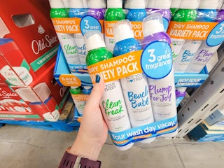 hand holding a 3-pack of not your mother's brand dry shampoo