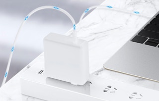 a Macbook charger plugged into an outlet